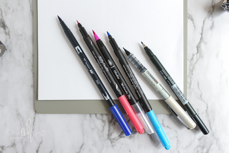 Assorted brush pens on desk