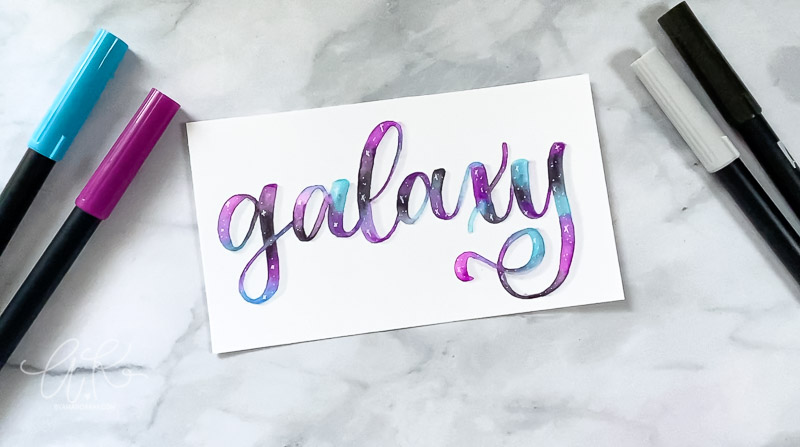 galaxy written in modern calligraphy with blues purples and black hues blended together