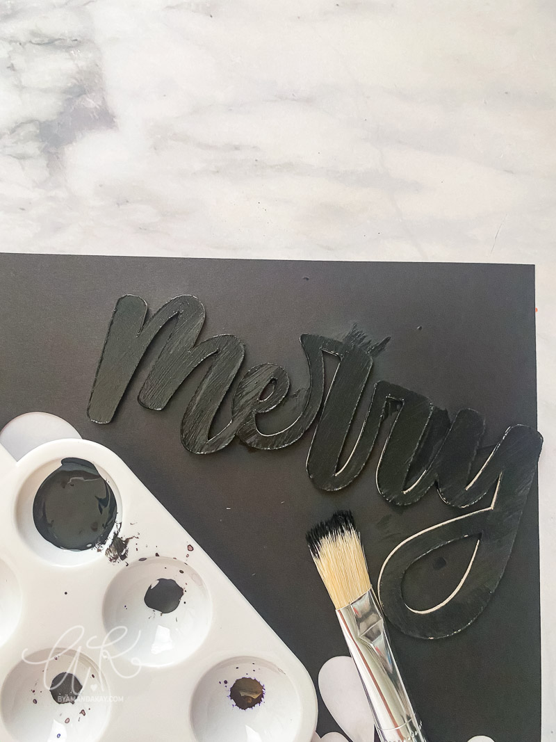 merry word ornament painted with black paint
